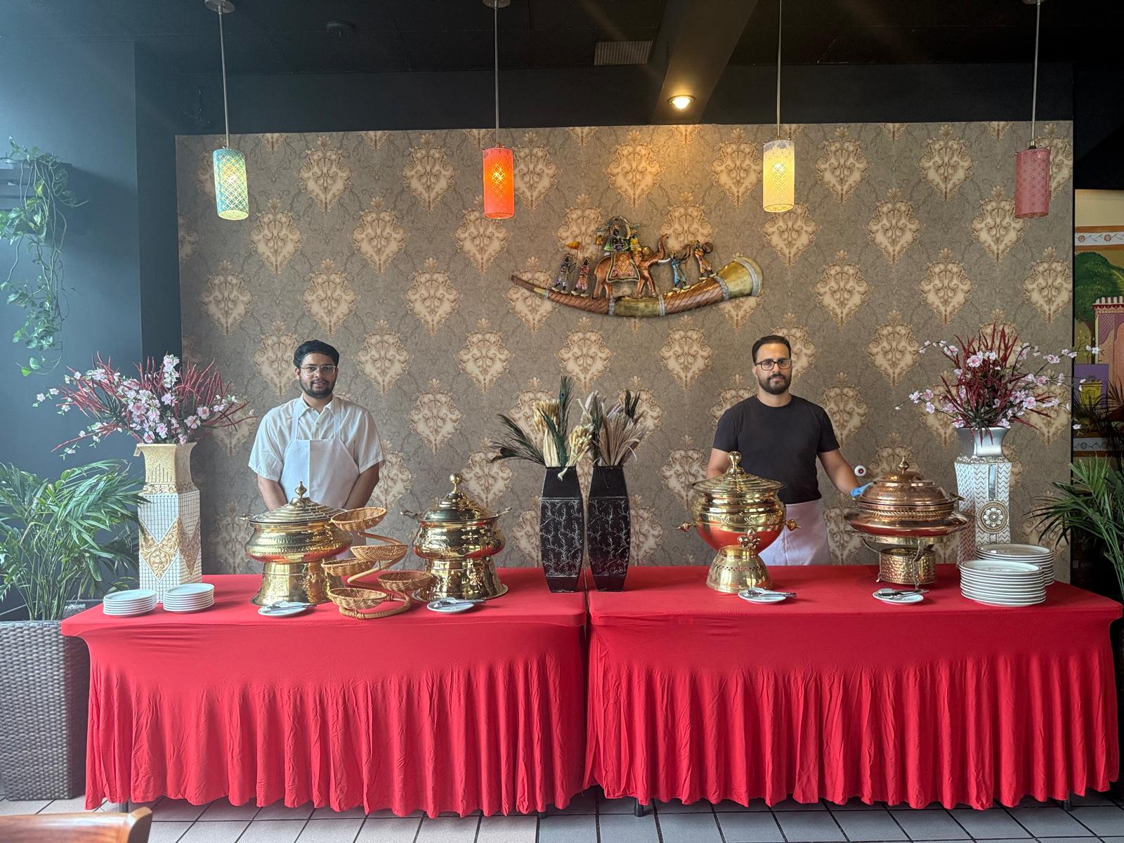 Catering team standing behind the buffet